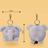 A plush elephant keychain shown from the front and back on a warm beige background, with dimension lines indicating 13 cm width, 9 cm height, and gold-tone clasp hardware.